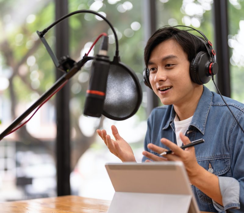 asian-male-podcaster-making-audio-podcast-from-her-home-studio.jpg
