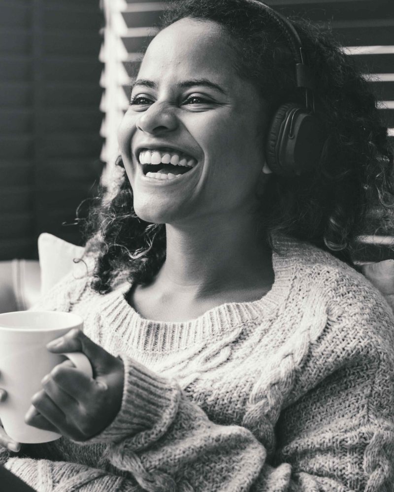 woman-enjoying-music-on-the-sofa-2023-11-27-05-07-20-utc-min