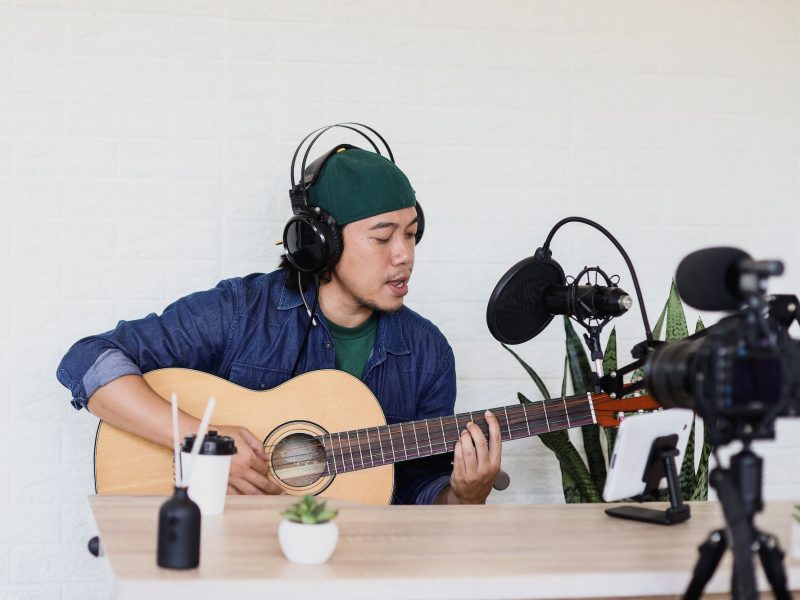 young-man-is-singing-and-play-guitar-on-music-podcast.jpg